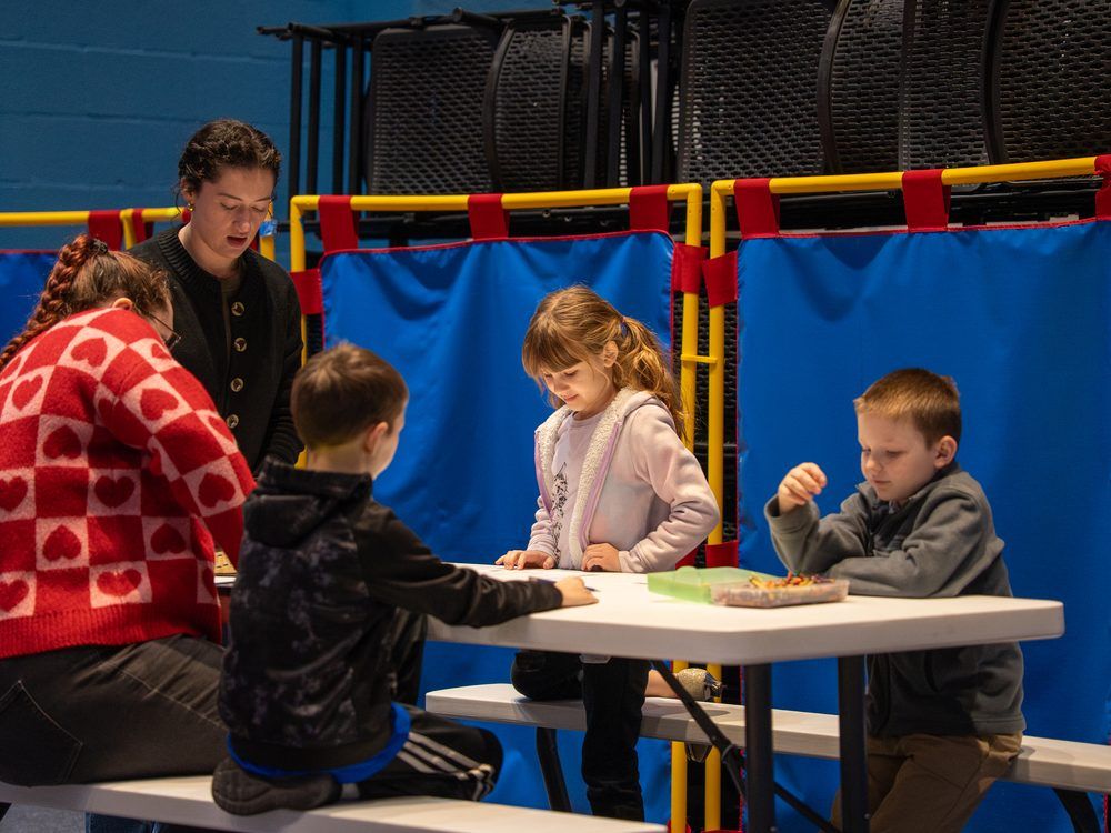Kids doing crafts at a table in the current Bay Life Kids space